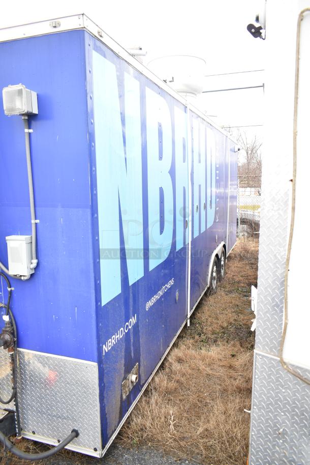 Commercial mobile kitchen trailer with CaptiveAire hood, Pitco propane fryers, and refrigeration. Blue exterior, used condition.