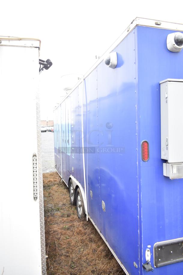 Blue mobile kitchen trailer with CaptiveAire hood, Pitco propane fryers, and refrigeration package. Good condition.