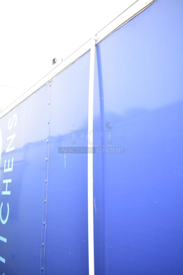 Commercial mobile kitchen trailer, blue exterior, CaptiveAire hood, Pitco propane fryers, complete refrigeration.