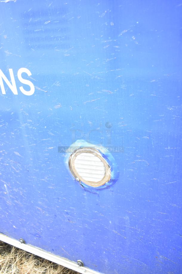 Blue exterior of a commercial mobile kitchen trailer, vent detail, shows signs of wear.