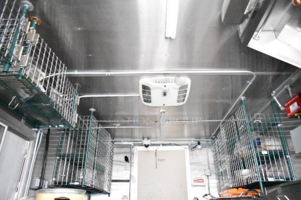 Fully equipped mobile kitchen trailer interior with CaptiveAire hood, Pitco propane fryers, and complete refrigeration package.
