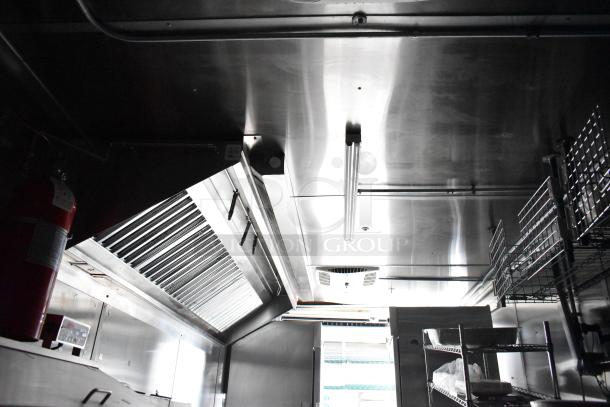 Fully equipped mobile kitchen trailer interior with CaptiveAire hood system, Pitco propane fryers, and complete refrigeration.