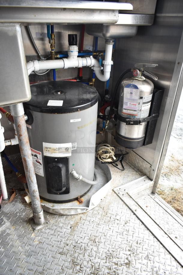 Fully equipped commercial mobile kitchen trailer interior, featuring CaptiveAire hood, Pitco propane fryers, and refrigeration.