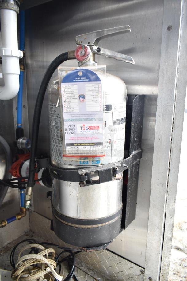 Mobile kitchen trailer with CaptiveAire hood, Pitco propane fryers, refrigeration. Includes fire extinguisher with inspection tags.