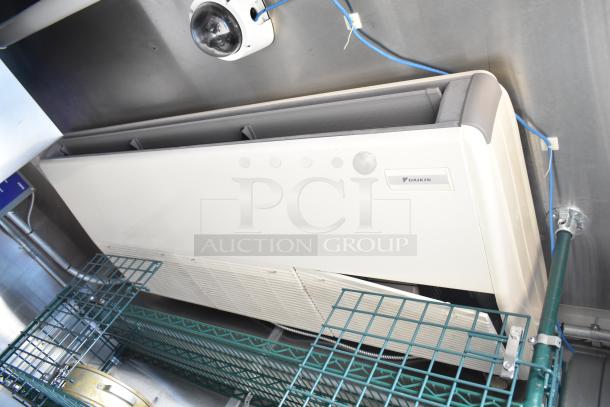 Commercial mobile kitchen trailer with Daikin refrigeration unit, steel shelving, and security camera. Includes CaptiveAire hood and Pitco fryers.