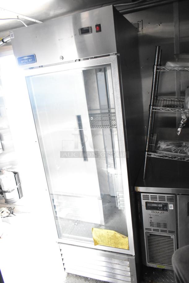 Fully equipped commercial mobile kitchen trailer with CaptiveAire hood, Pitco propane fryers, and Arctic Air refrigeration.