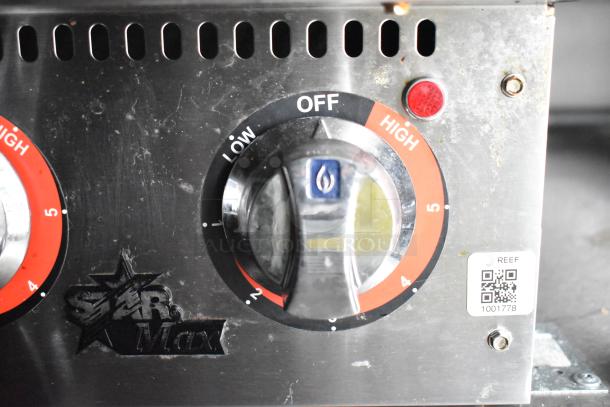 Knob control on Star Max appliance with settings from low to high, featuring QR code and REEF label on metal surface.