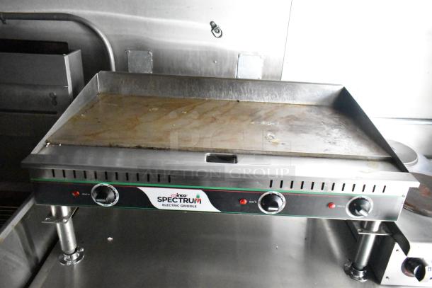 Commercial mobile kitchen trailer with Winco Spectrum electric griddle, CaptiveAire hood, and Pitco propane fryers.