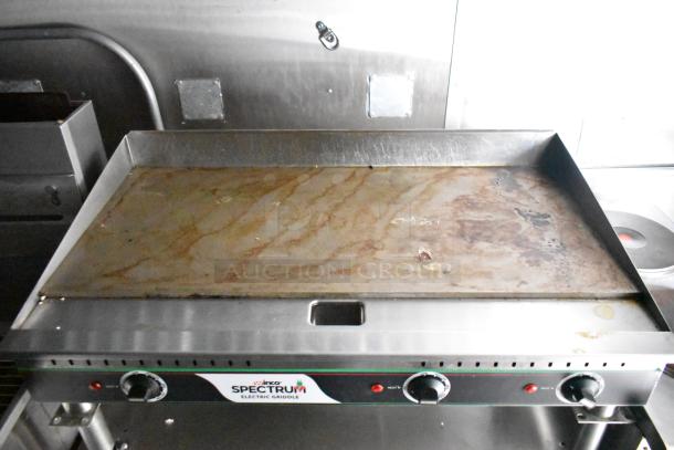 Vinco Spectrum electric griddle in a commercial mobile kitchen trailer, featuring CaptiveAire hood, Pitco fryers, and refrigeration package.