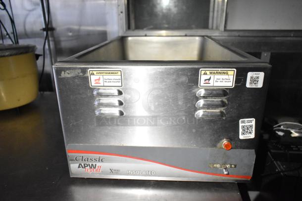 Fully equipped commercial kitchen trailer with CaptiveAire hood, Pitco propane fryers, full refrigeration package, visible warning labels.