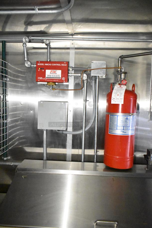 Commercial mobile kitchen trailer with CaptiveAire hood, Pitco propane fryer, and fire safety equipment. Stainless steel interior.