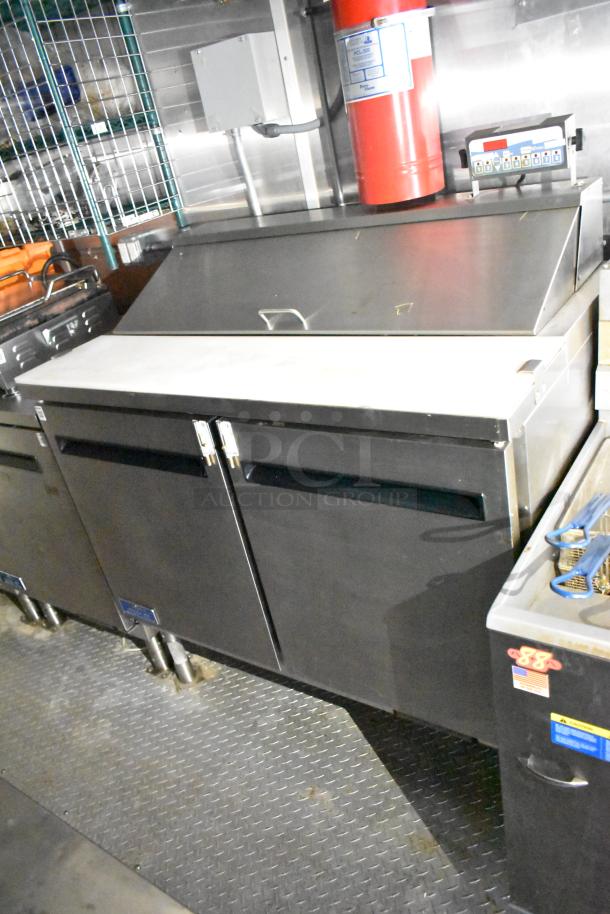 Fully equipped mobile kitchen trailer with CaptiveAire hood, Pitco propane fryers, and complete refrigeration in excellent condition.