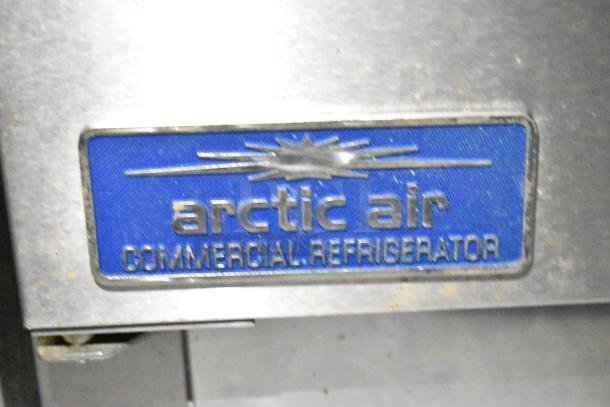 "Arctic Air Commercial Refrigerator blue label on a kitchen trailer appliance, indicating refrigeration component."