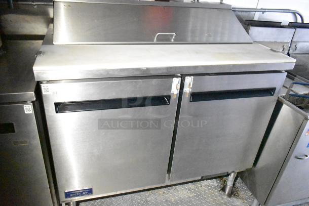 Mobile kitchen trailer with CaptiveAire hood, Pitco propane fryers, complete refrigeration, Arctic Air freezer.