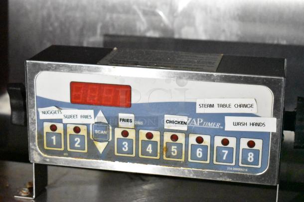 Timer control panel with numbered buttons and labels for food items and tasks, indicating customizable settings for kitchen operations.
