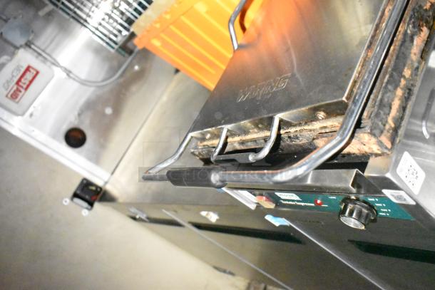 Commercial mobile kitchen trailer featuring a CaptiveAire hood, Pitco propane fryers, and stainless steel equipment.