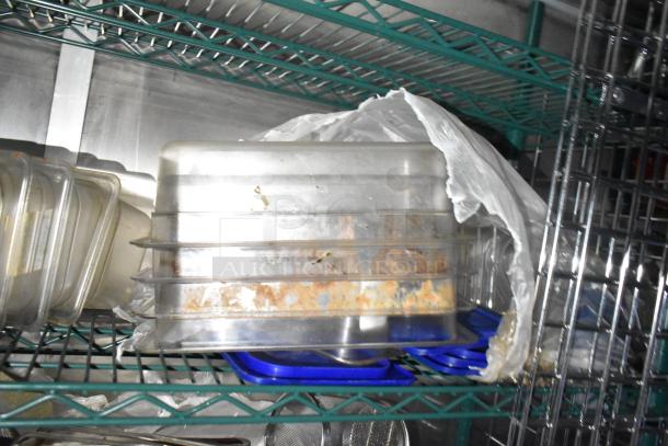 "Organized shelves in a commercial mobile kitchen trailer showing stored plastic containers, indicating food preparation use."