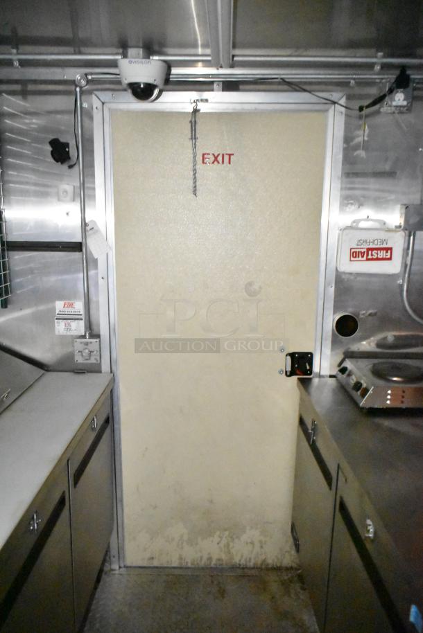 Fully equipped commercial mobile kitchen trailer interior with CaptiveAire hood, Pitco propane fryers, and first aid kit.