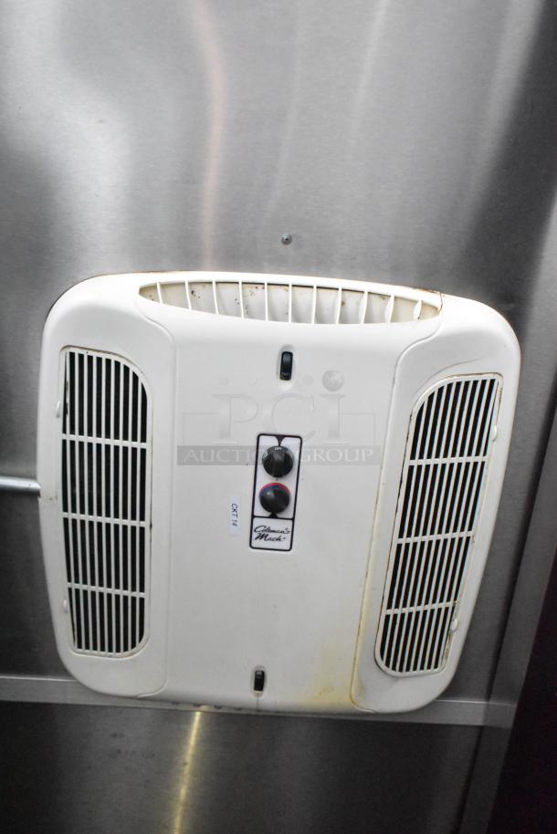 Commercial mobile kitchen trailer with Coleman-Mach air vent. Features stainless steel interior. Moderate wear visible.