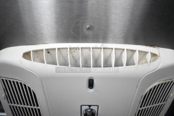 Close-up of a vent in a commercial mobile kitchen trailer, featuring a CaptiveAire hood system. Visible dust and grime.