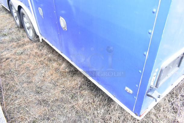 Blue commercial mobile kitchen trailer, equipped with CaptiveAire hood, Pitco propane fryers, complete refrigeration.