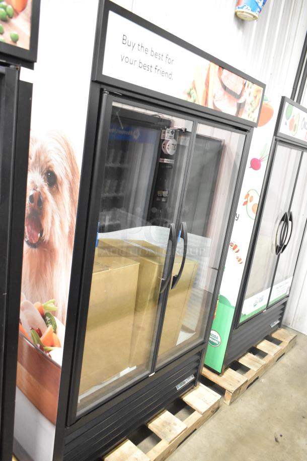 Brand new 2025 True TVM-48SL-HC commercial 2-door cooler. Scratch and dent condition. Displays "Buy the best for your best friend."