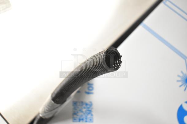 Coiled black hose on a 2025 Manitowoc UDP0065A-161 commercial ice machine box. Scratch and dent condition.