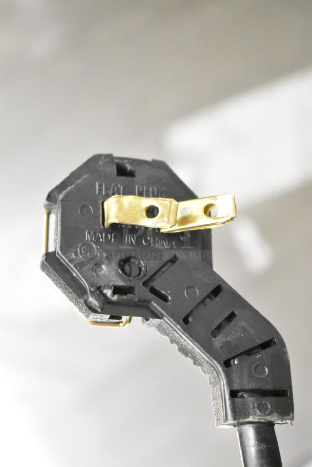 Close-up of power plug on Manitowoc UDP0065A-161 ice machine, showing "Flat Plug" and "Made in China" markings.