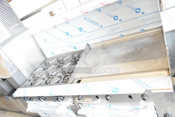 Brand new Vulcan 72SS-6B36GTN commercial range with 6 burners, 36" griddle, 2 ovens, 310,000 BTU, protective wrap visible.