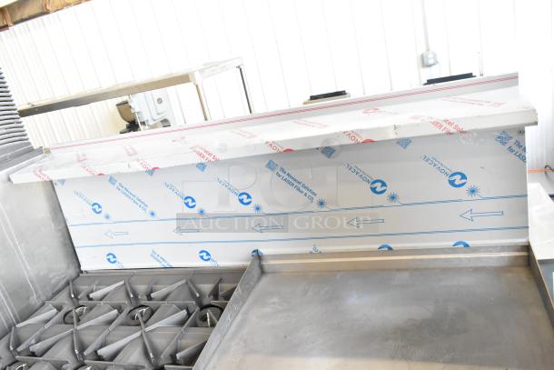 Brand new Vulcan 72SS-6B36GTN commercial range with 6 burners, 36" griddle, 2 ovens, 310,000 BTU; scratch and dent condition.