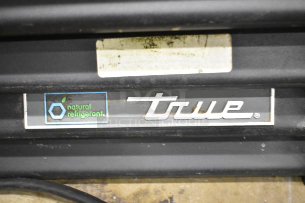 2018 True GDM-72F-HC 3-door reach-in freezer merchandiser, natural refrigerant label, model plate visible.