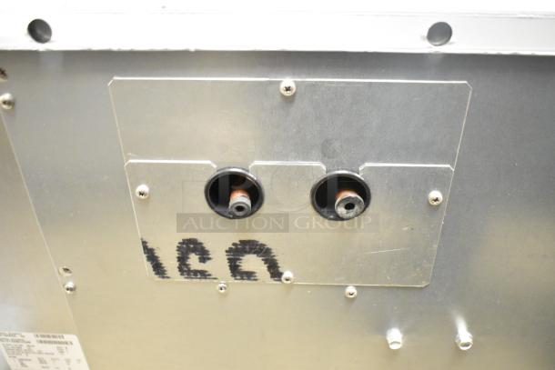 Back view of Scotsman MC1030SR-3A ice machine showing connection ports and serial number tag; brand new, minor scratches.