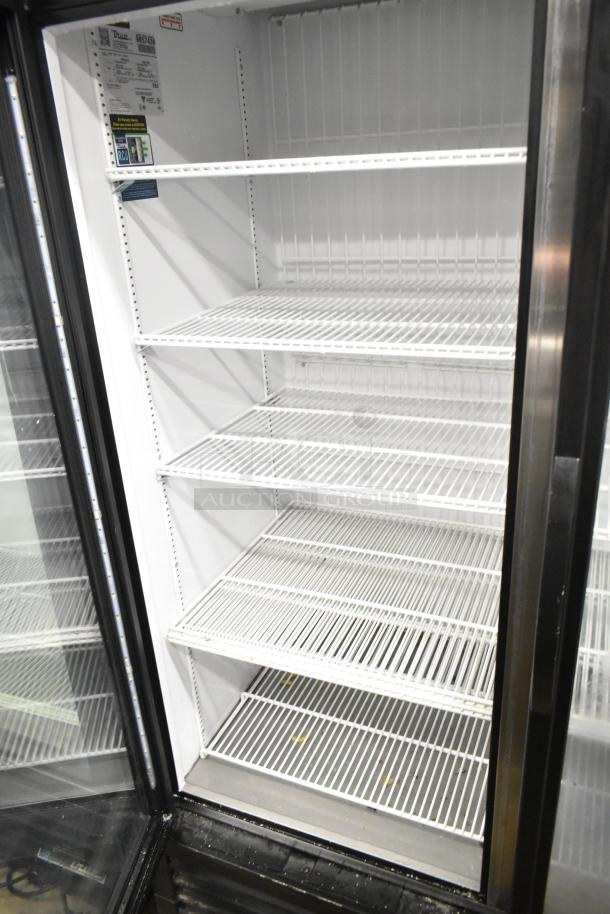2020 True GDM-49F-HC two-door reach-in freezer with multiple wire shelves, label shows 115/208-230V, 1 phase.