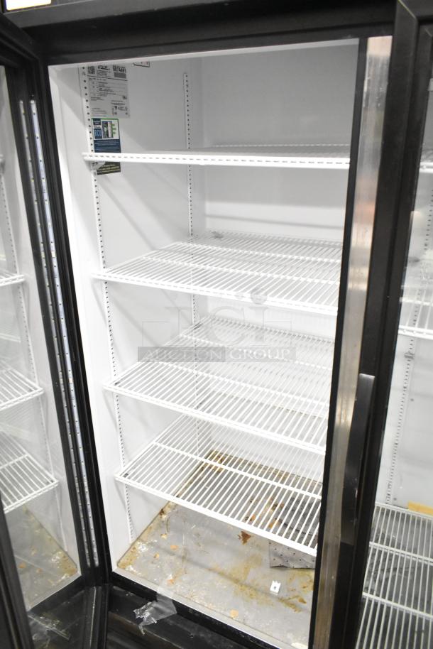 2020 True GDM-49-HC Commercial 2 Door Cooler Merchandiser, white wire racks, fair condition, label showing model and power spec.