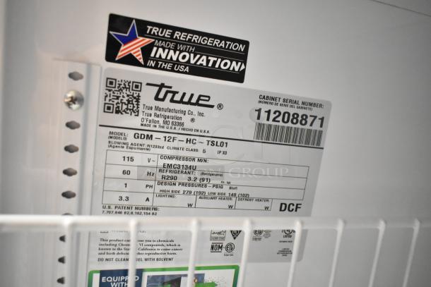 Label inside 2025 True GDM-12F-HC commercial cooler showing model number, specifications, and serial number 11208871.