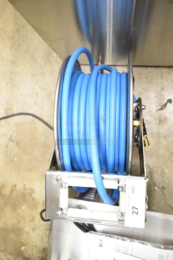Brand new Regency air-water hose on reel, blue, with scratch and dent condition. Includes visible tag marked "27."
