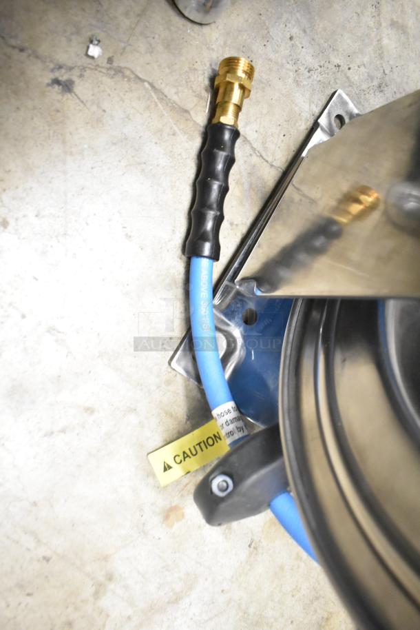 BRAND NEW SCRATCH AND DENT Regency air-water hose on reel, blue hose with black grip, brass fitting, caution label visible.