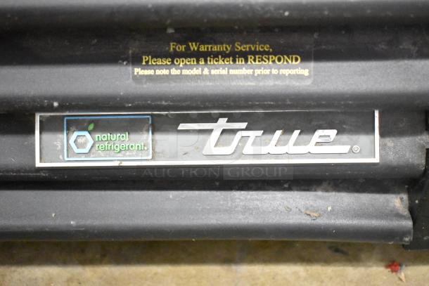2018 True GDM-72-HC commercial cooler label showing "natural refrigerant" and True logo. Warranty service instructions visible.