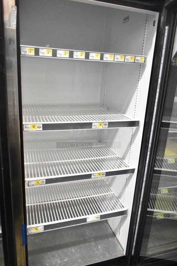 2018 True GDM-72-HC commercial 3-door cooler, reach-in merchandiser, 115 volts, 1 phase, shelves labeled with prices.