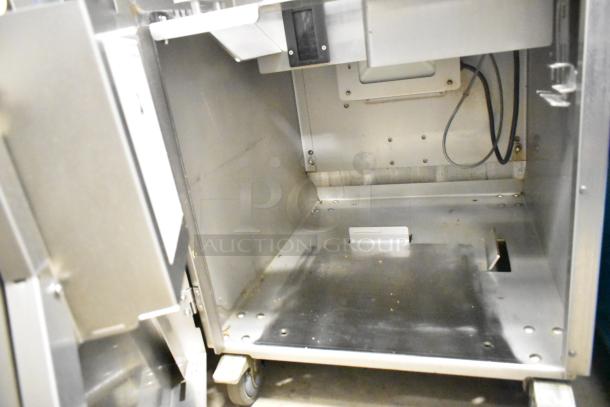 LATE MODEL JBT 2ND-GEN-MFJ-HE citrus juicer, floor style on casters, commercial use, 115V, 1 Phase, interior view.