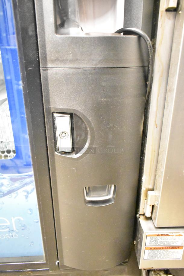 Crane 5800-4 metal vending machine with bill acceptor, 115 volts, 1 phase, showing coin slot and warning labels.