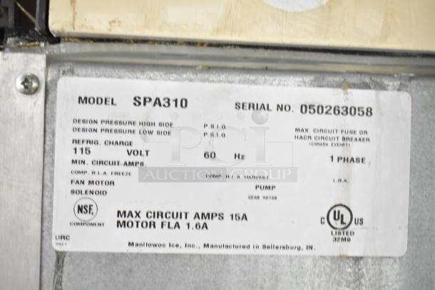 Manitowoc SPA310 label showing model, serial number, voltage, and phase specifications for the commercial ice machine.