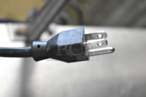 Manitowoc SD0452A ice machine head on SPA310 dispenser, 115V, 1 phase plug, black cord, close-up of prongs.