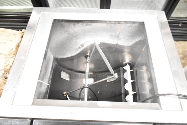 Commercial countertop beverage dispenser, stainless steel. 115 volts, 1 phase. Visible interior components. Good condition.