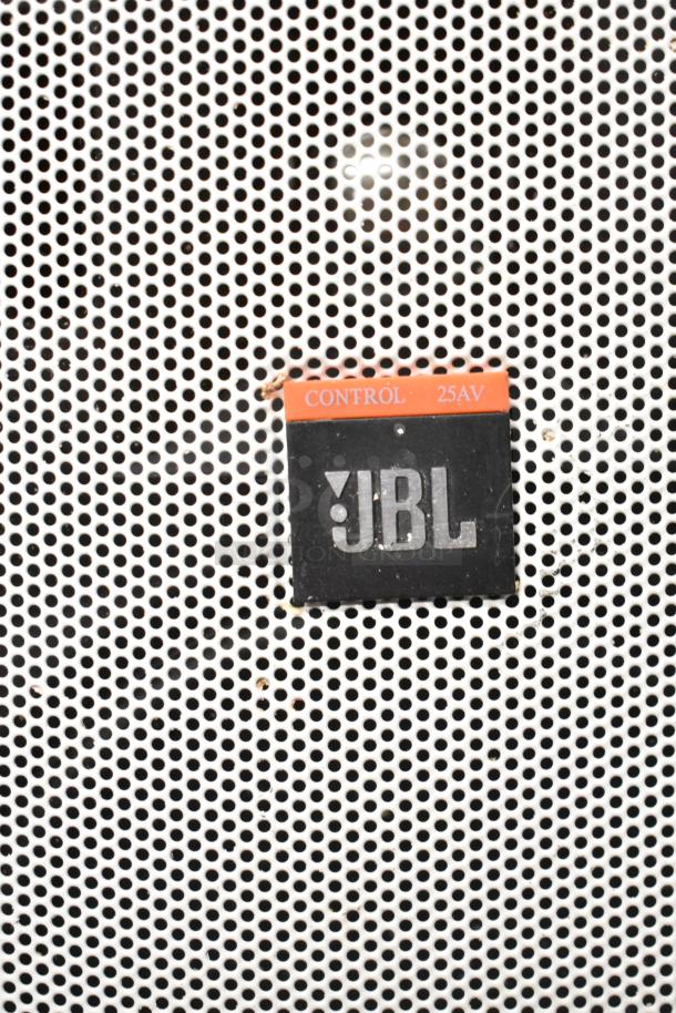 JBL Control 25AV speaker close-up showing logo and model on perforated metal grille.