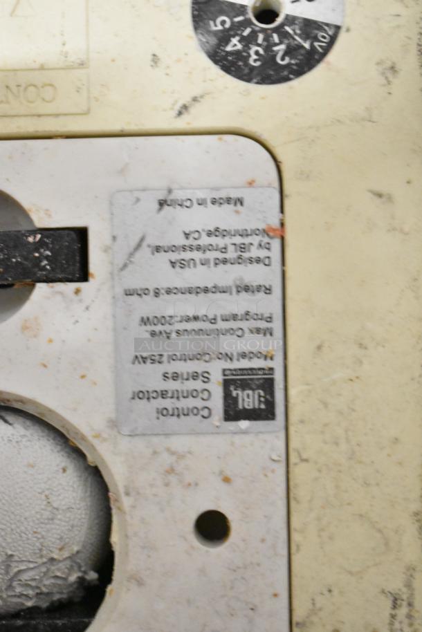 Close-up of JBL Control 25AV speaker label with specs: max power 200W, made in China, presents signs of wear.