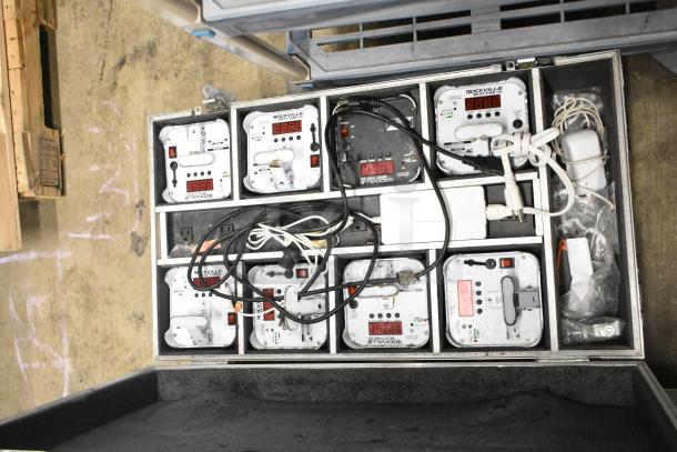 8 various items including JBL Control 25AV speakers and Rockville Best Par 50 battery par wash lights in a hard case.