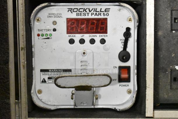 Rockville Best Par 50 control panel with wireless DMX signal, battery indicators, and warning label visible in a hard case.
