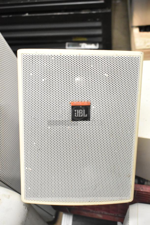 JBL Control 25AV speaker with perforated grille and logo; part of an auction including lights and hard case.