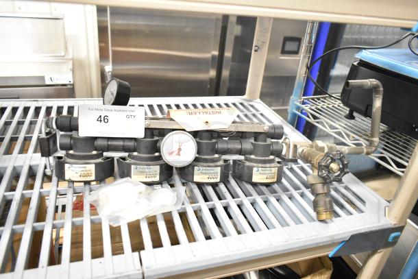 Everpure InsurIce 4000 Water Filtration System, featuring multiple filter units, pressure gauge, and labeled components. Good condition.